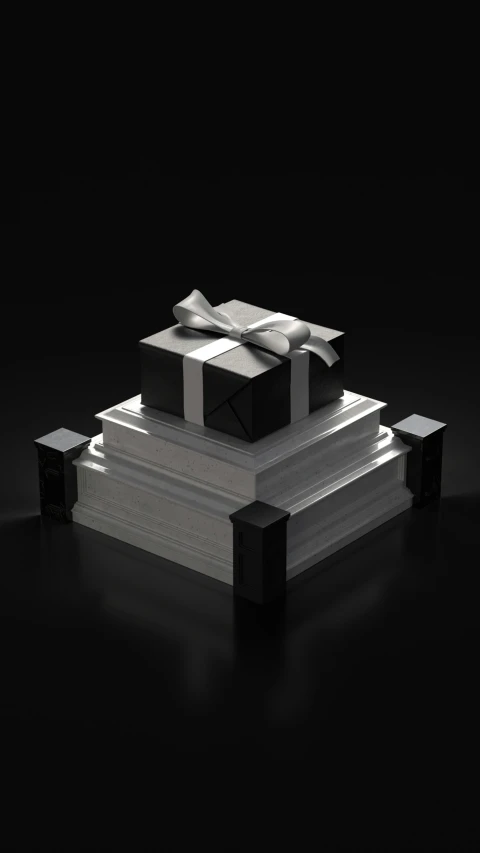 a large, black present box sitting on two large, white boxes