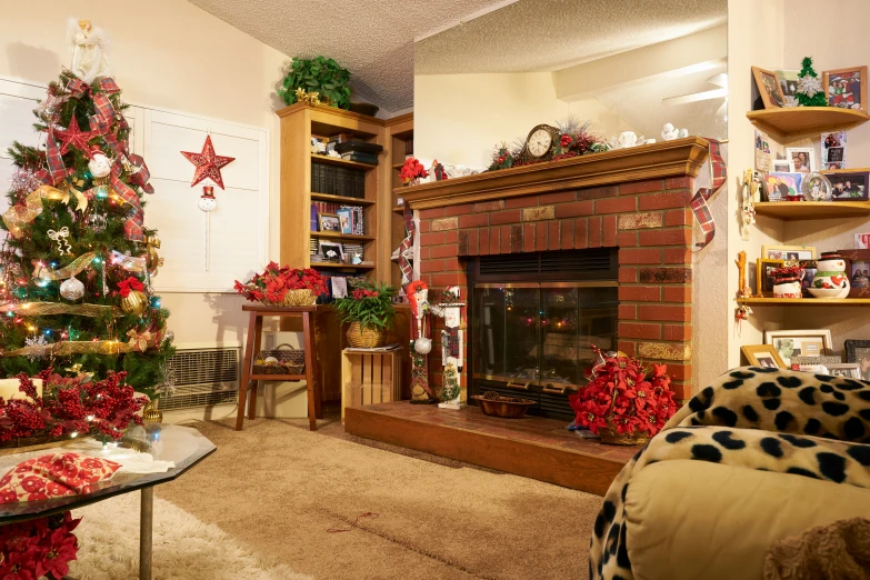 a decorated christmas tree sitting in front of a fire place