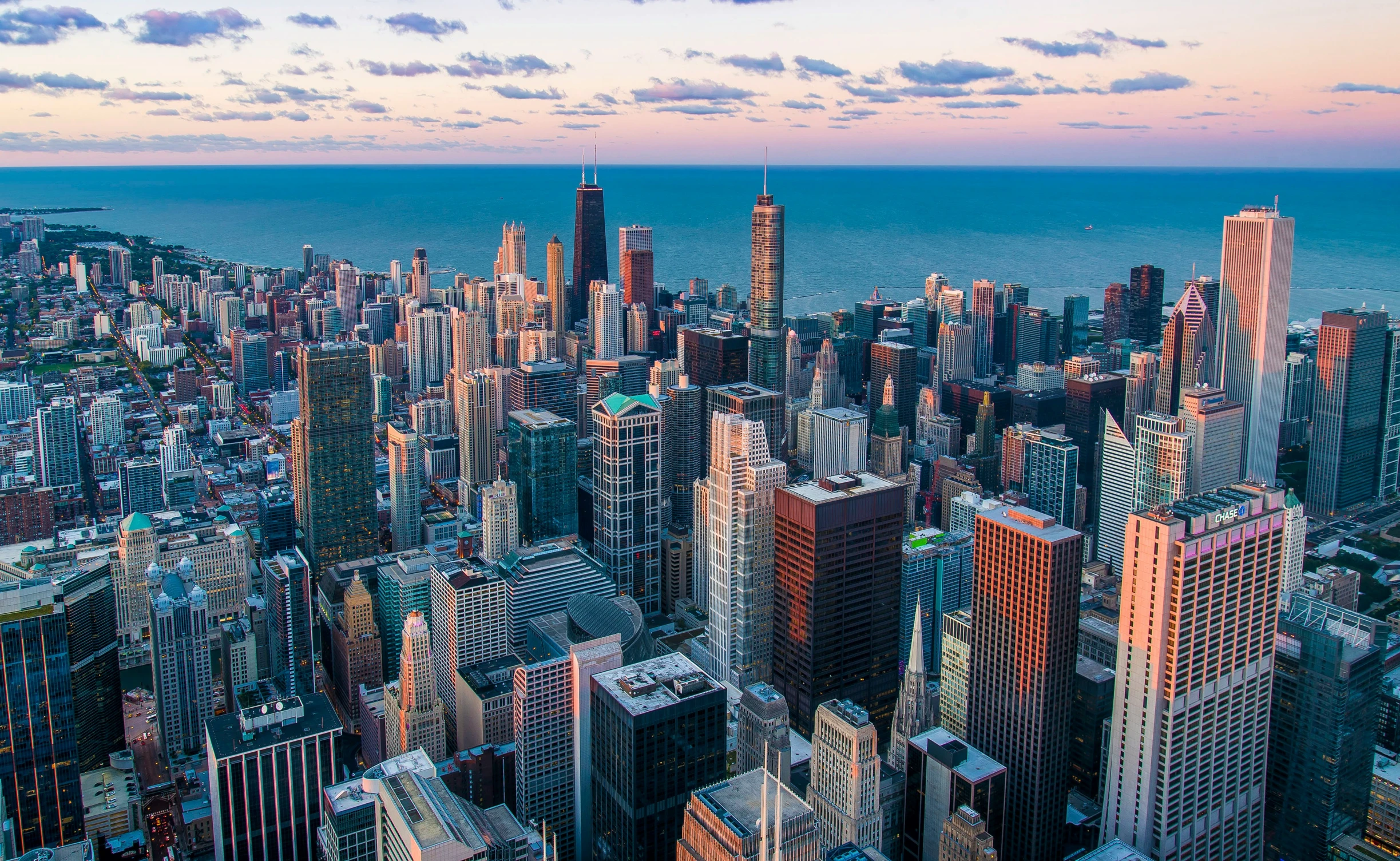 a beautiful view of some tall buildings near the ocean