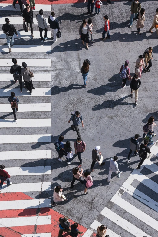 a group of people walking across a crosswalk