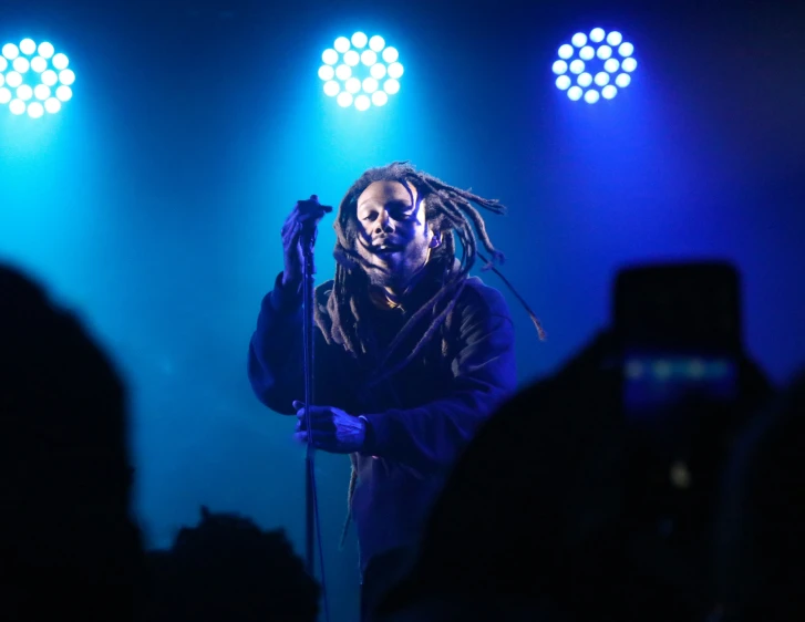 a person on stage holding a microphone