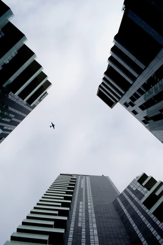 a tall building surrounded by buildings in the middle of the sky