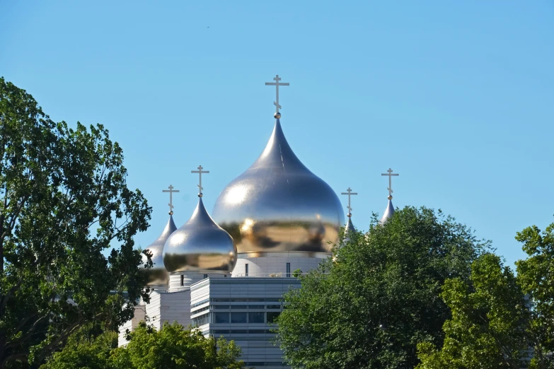 a building with three steeples and a cross on the top of one