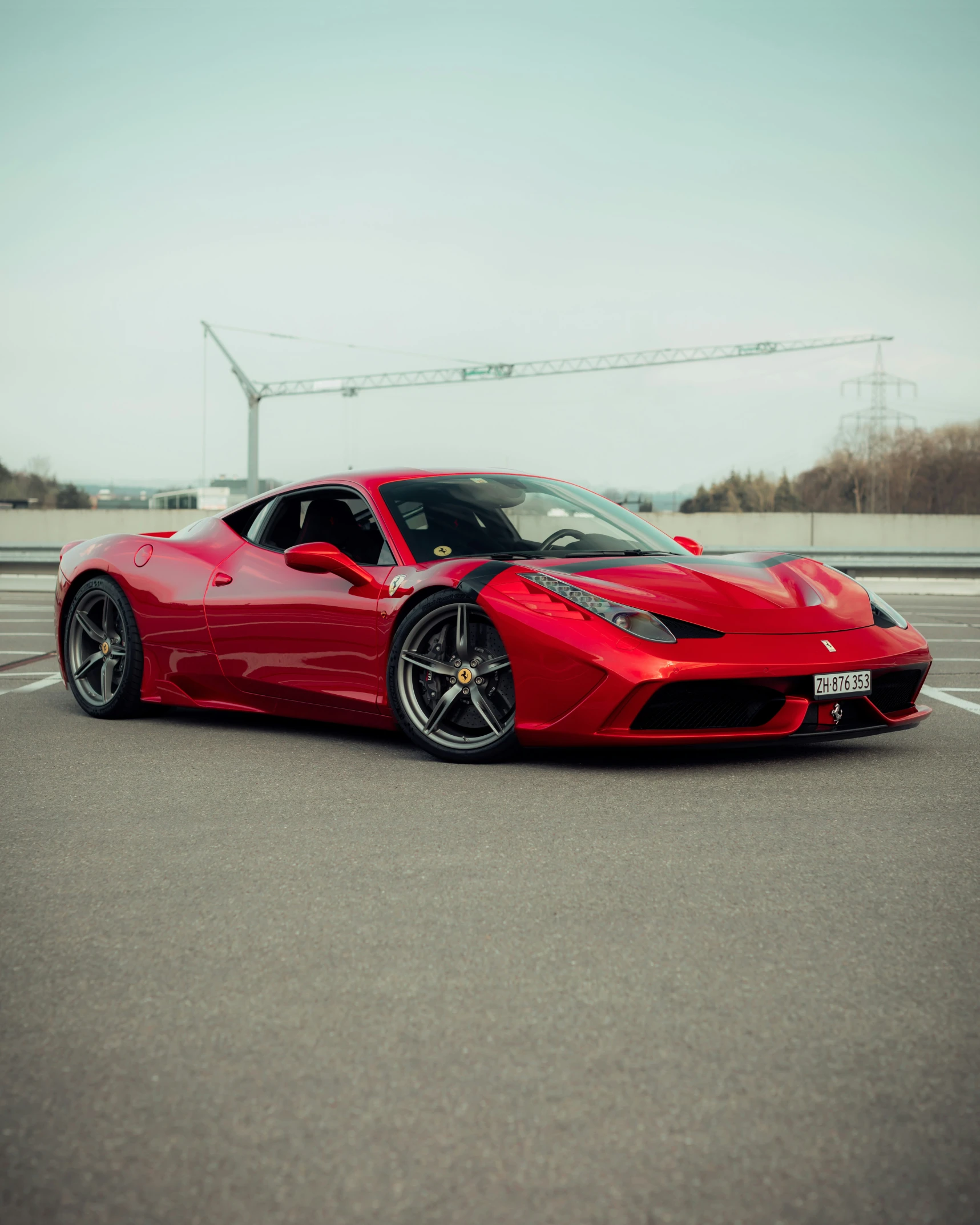 red sports car parked in the parking lot