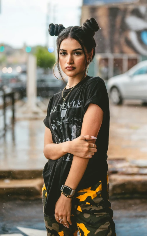 an asian woman in black is holding her arms crossed