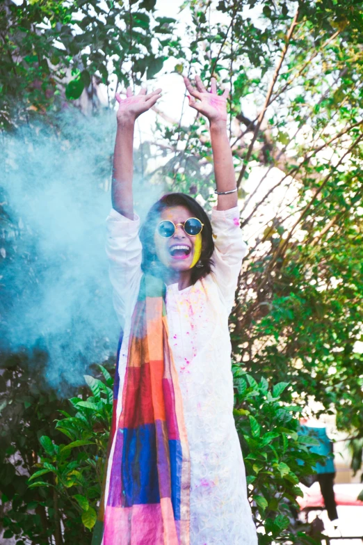 a young woman standing on a street holding up her hands