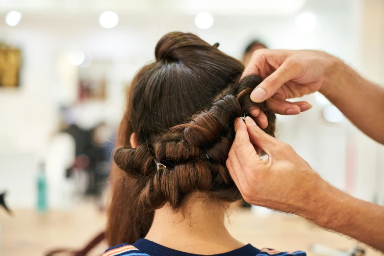 a person  another persons hair in a salon