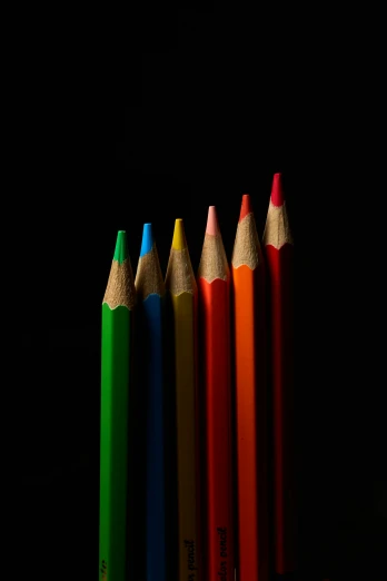 a group of four pencils standing in a row