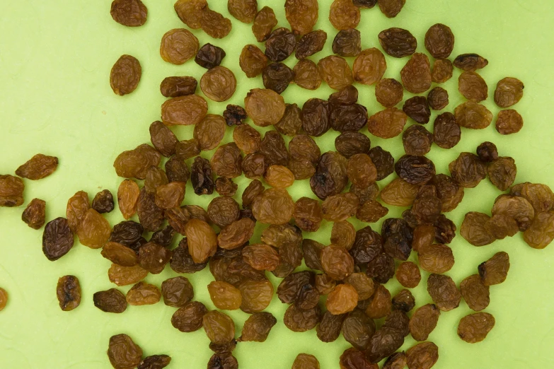 close up view of raisins on green cloth