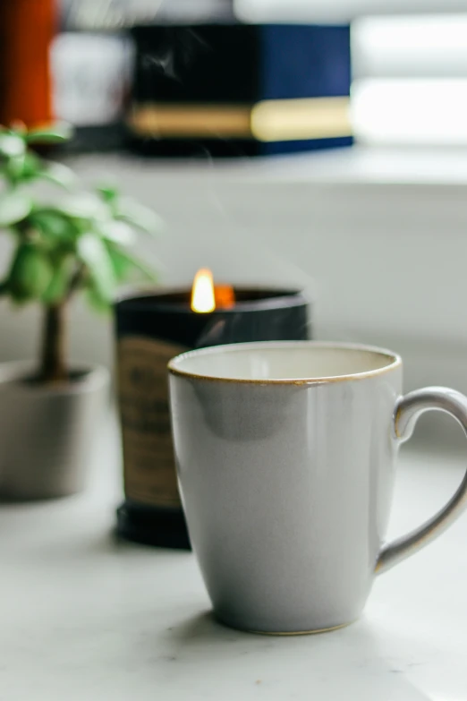 coffee cup sitting on a table next to some potted plants