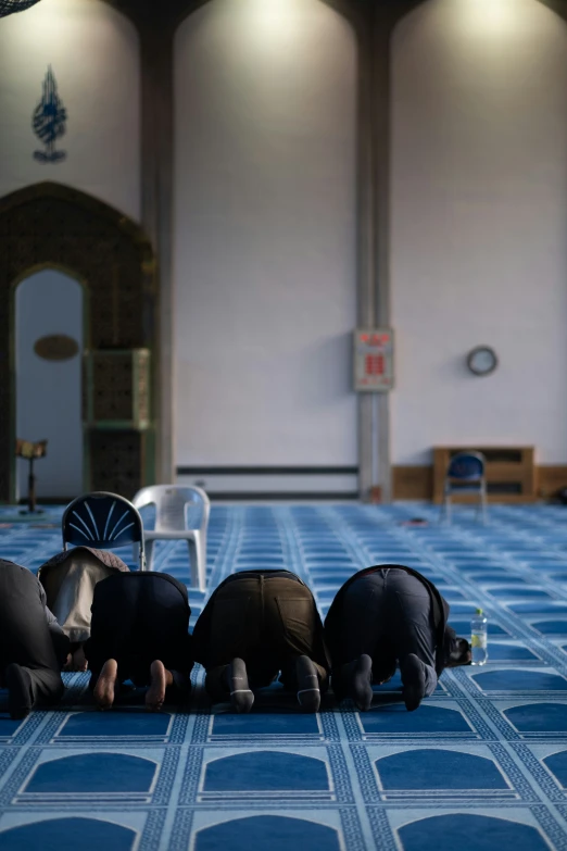 five elephants are standing in a line on a blue carpet