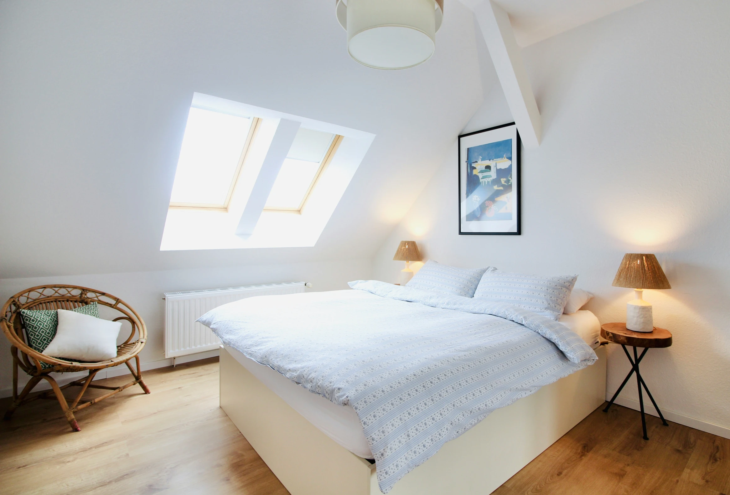 a bed with a white linen on it in a bedroom