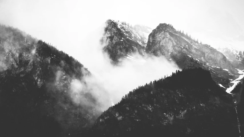 black and white pograph of mountains with clouds