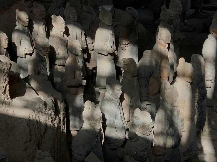 a group of statues stand next to each other