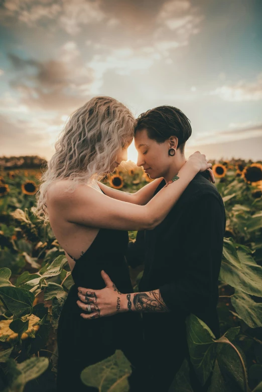 a man and a woman in a field of sunflowers