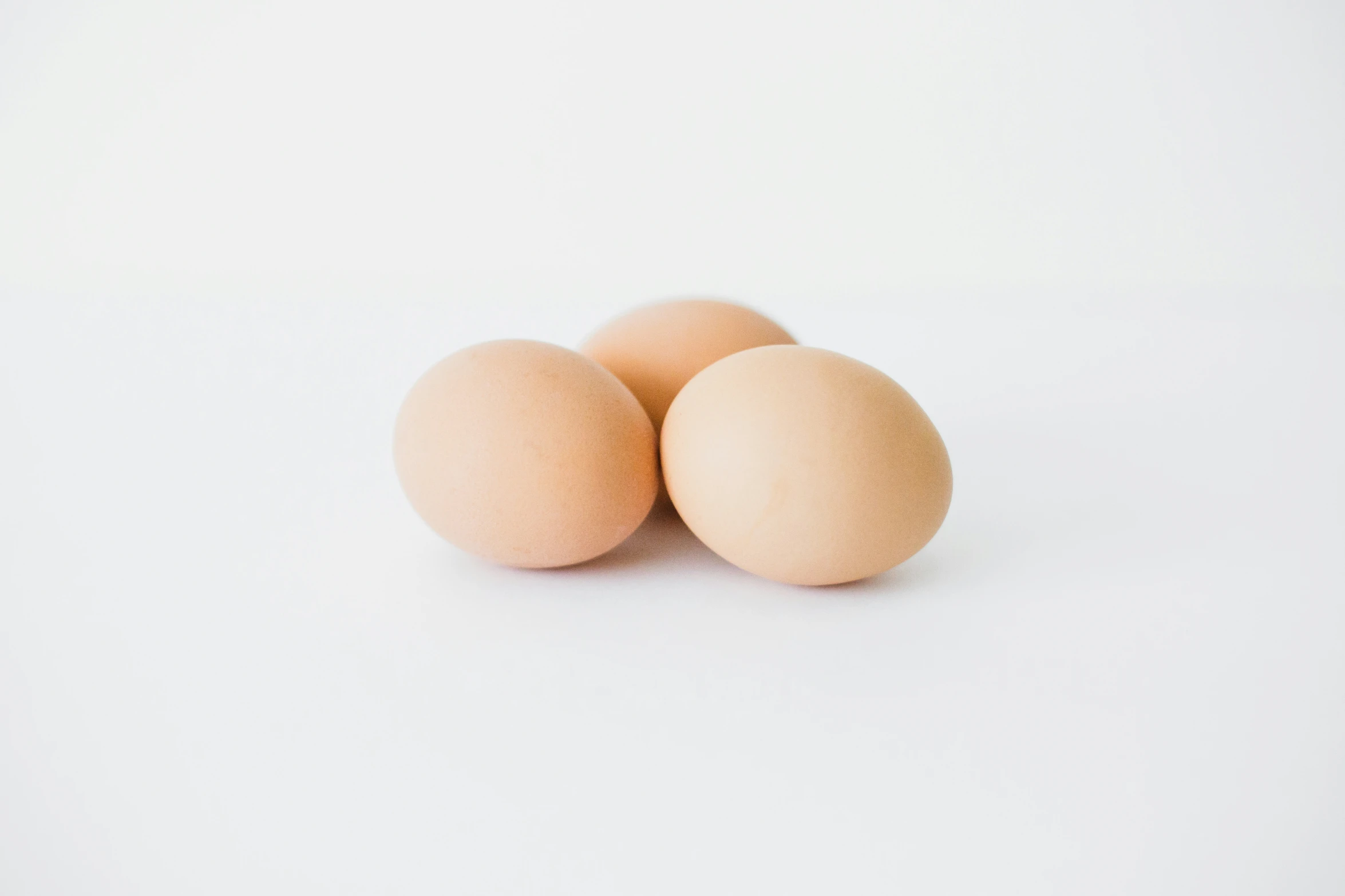 four eggs sitting next to each other on a table