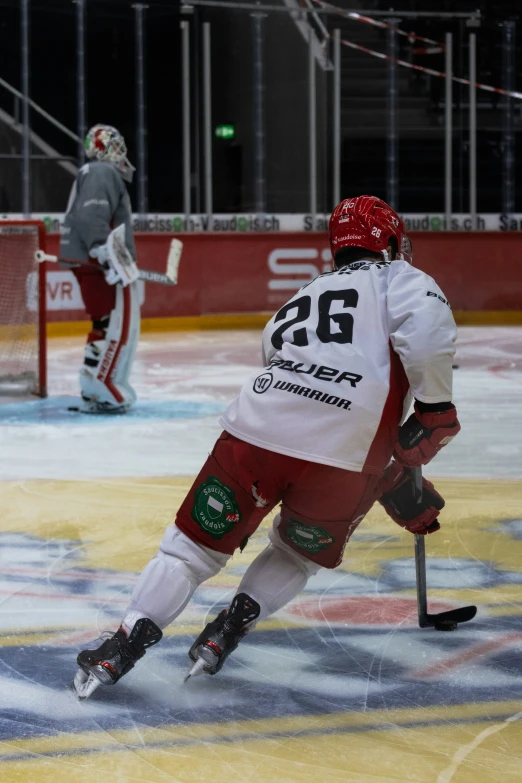 the men are playing ice hockey on the rink