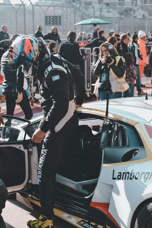 a motorcycle racer getting out of his race car