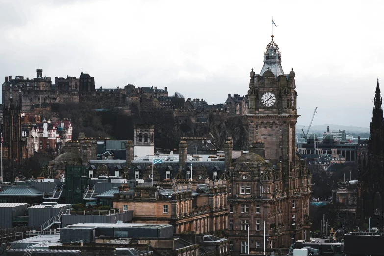 a very tall clock tower towering over a city