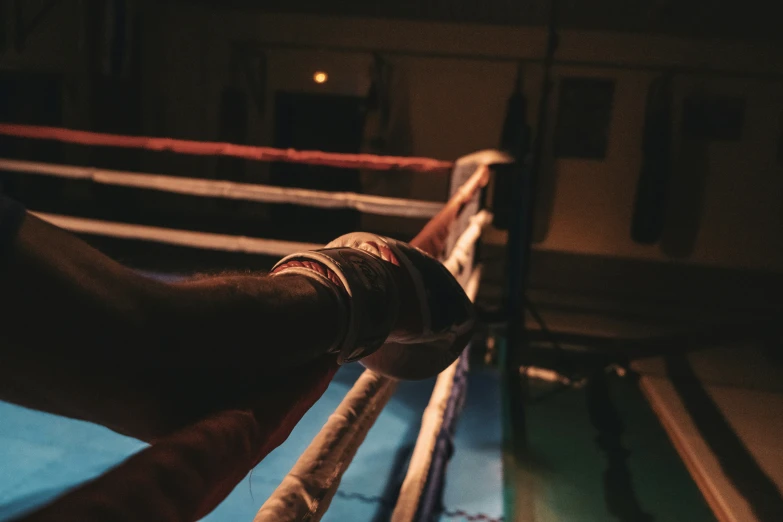 a person taking a picture of the ropes of a boxing ring