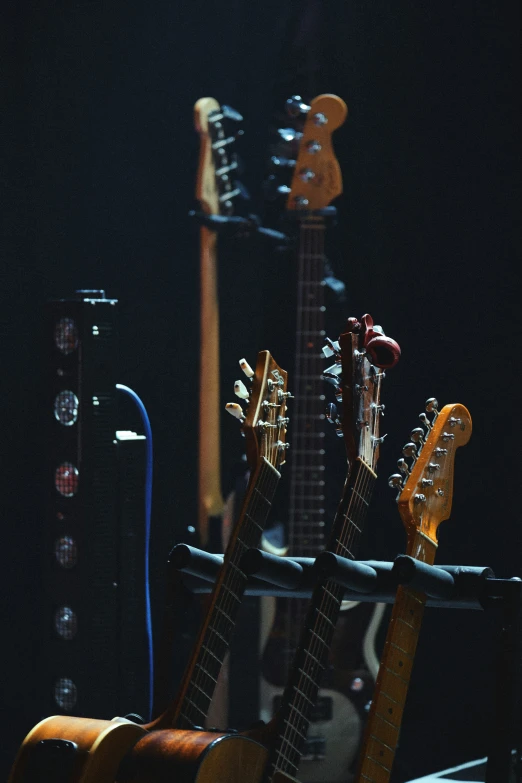 several guitars are stacked together in a room