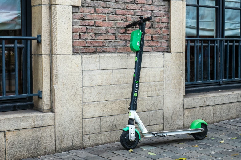 a scooter leaning against the side of a building