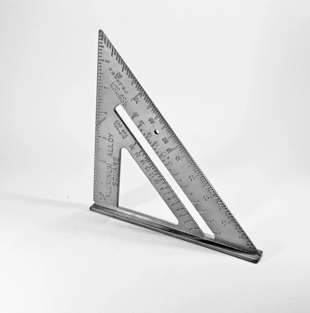 a set of four metal rulers on top of a white background