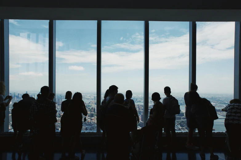 a group of people standing together looking out at the city