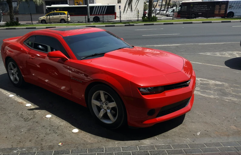 a red sports car is parked in a parking lot