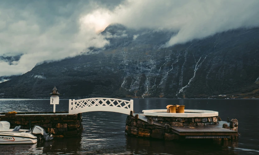 a white bridge in the middle of water with boats