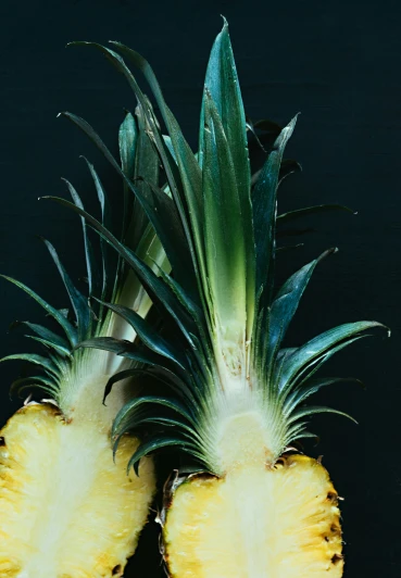 a pineapple cut in half with one sitting inside