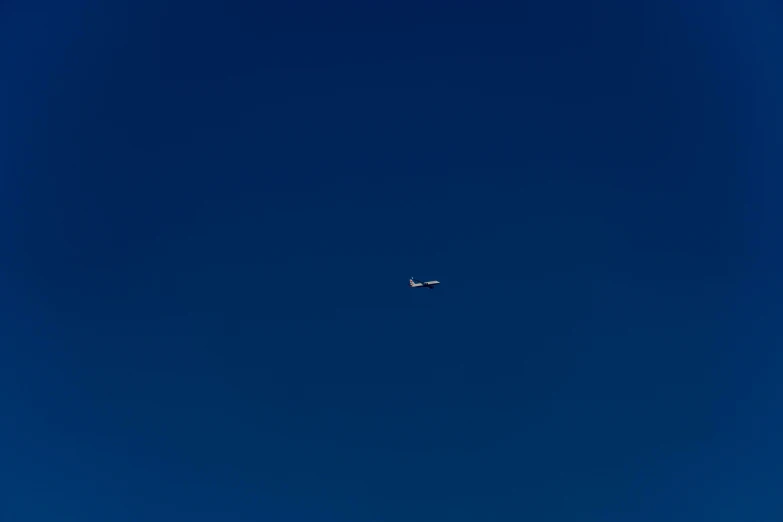 an airplane flying in the sky on a clear day