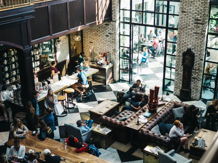 a group of people gather in a lobby full of people