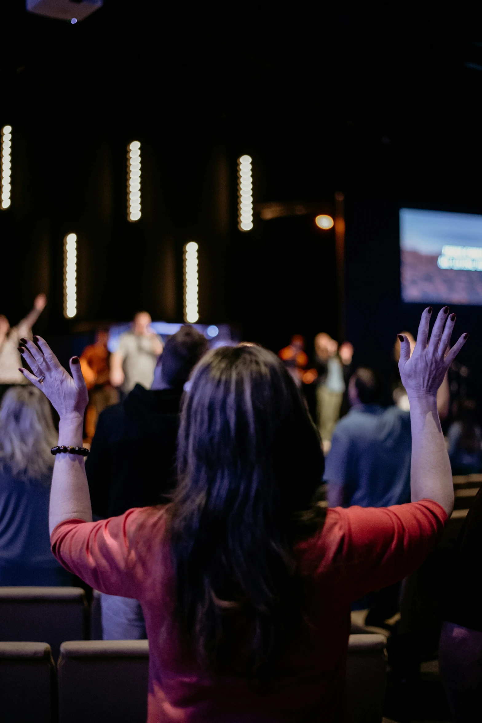 people clapping in an auditorium with people watching and clapping