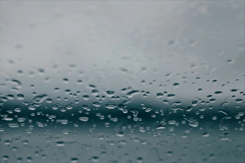 a rain drops down the window of a car