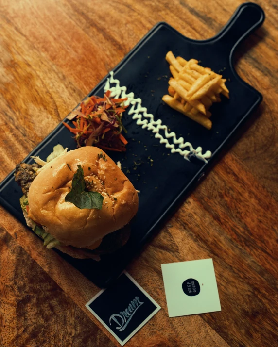 a tray holds fries, hamburger and other items