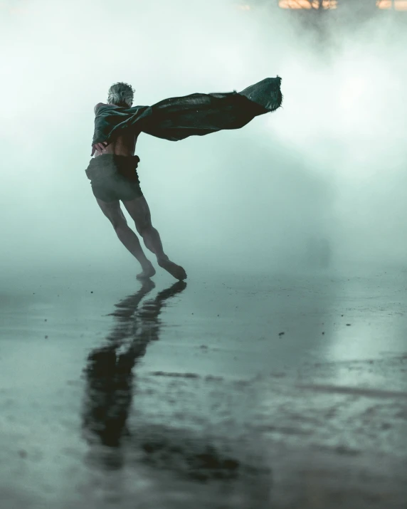 a person in the middle of the fog and water