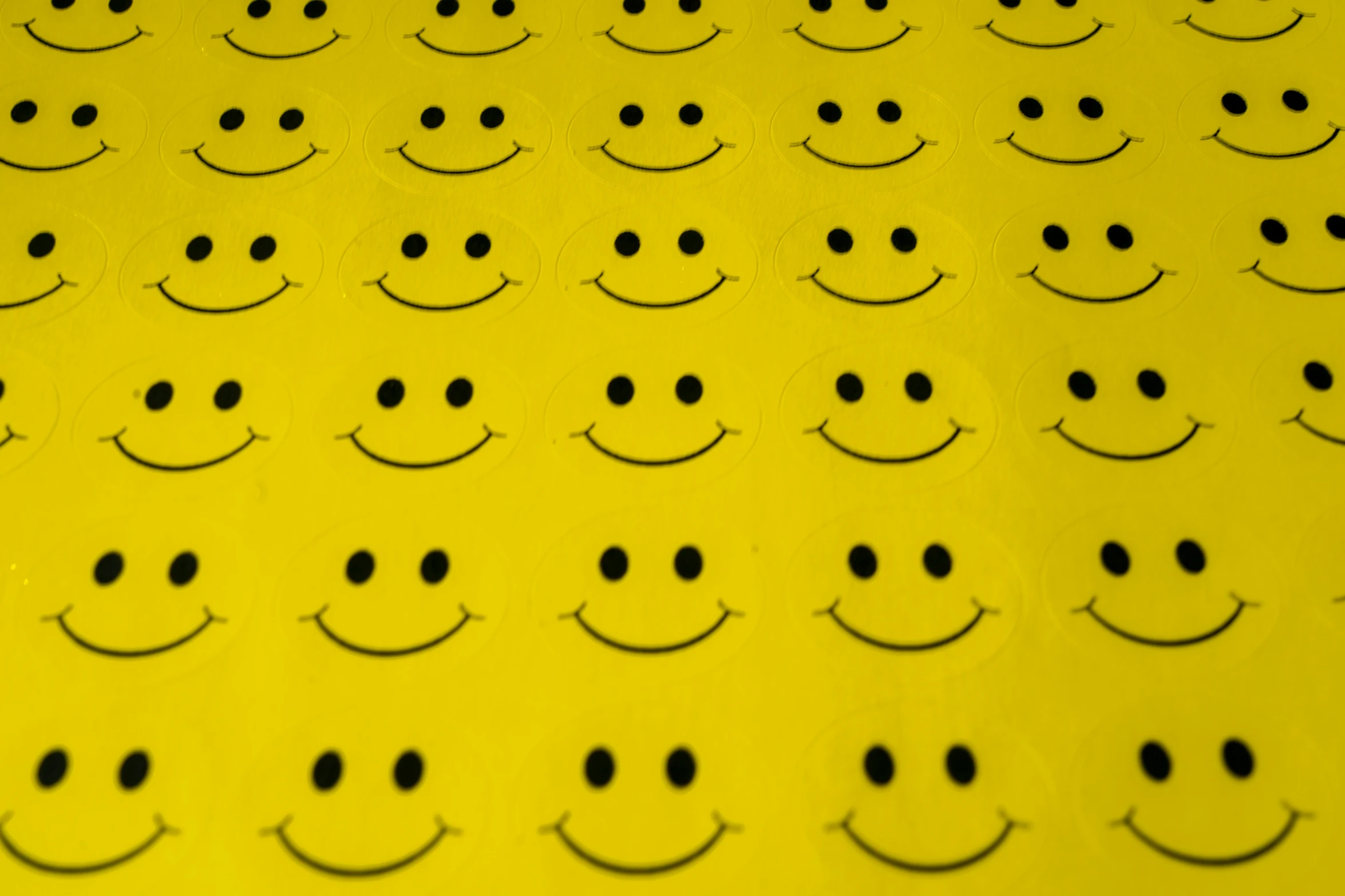 a bunch of yellow smiley faces that are placed next to each other