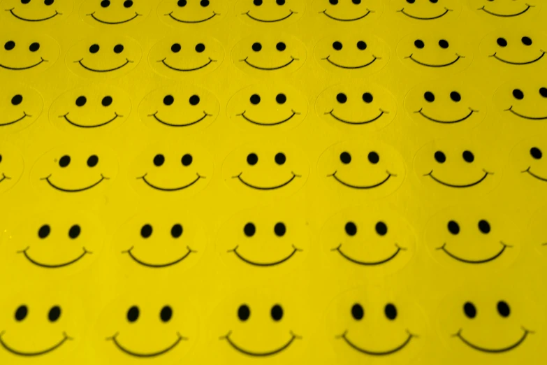 a bunch of yellow smiley faces that are placed next to each other