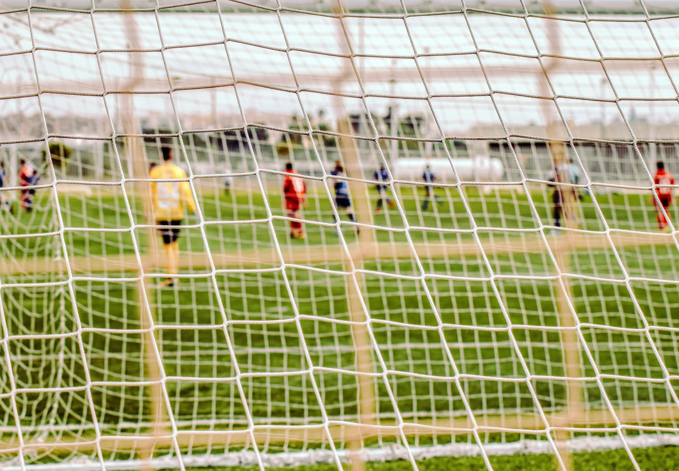 some players on a field playing with a soccer ball