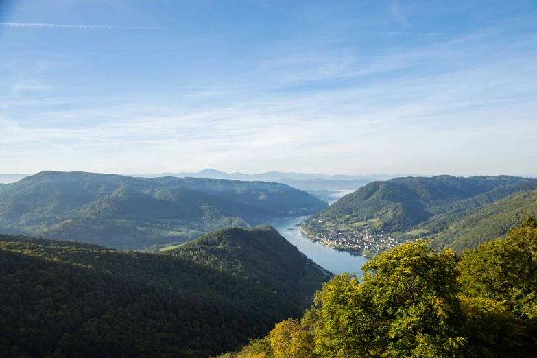 the valley below is covered by lots of green trees