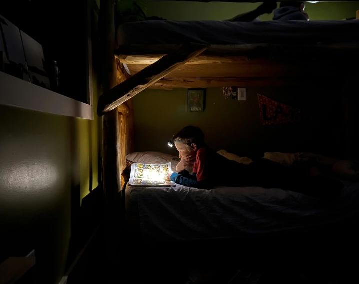 a young child is sitting on a bed