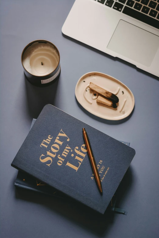 the travel journal and pen are sitting on the desk