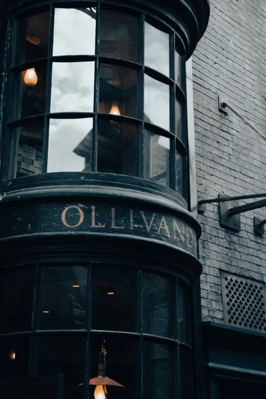 an old fashion storefront with a lighted umbrella hanging out the window