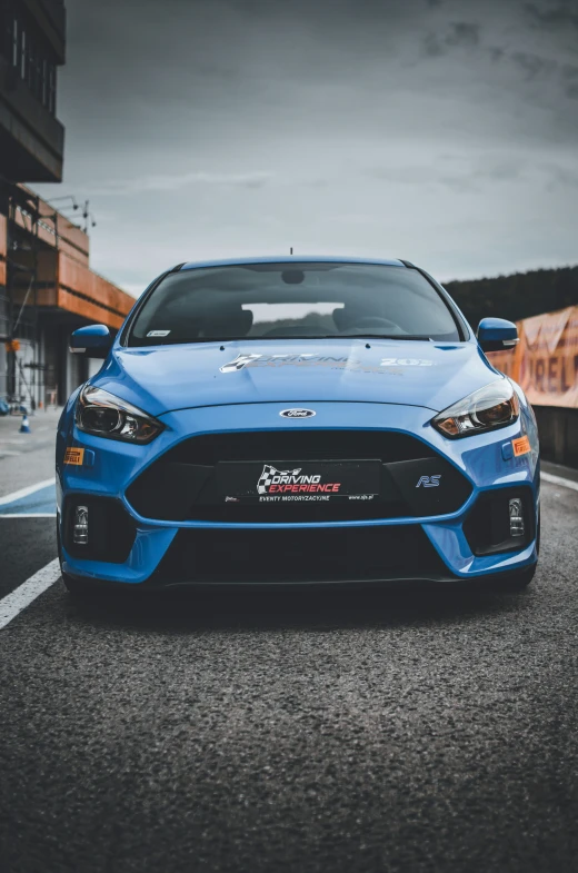 a very blue sport car sitting on the road