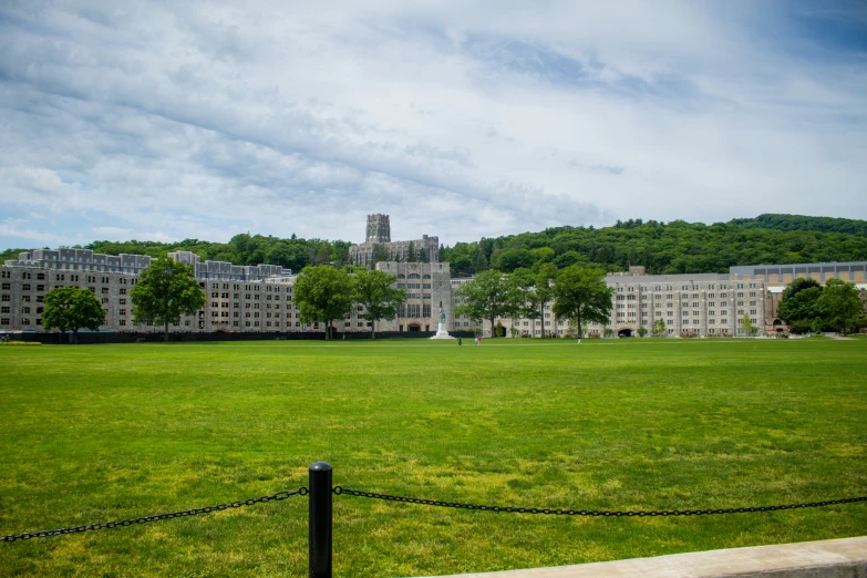 a view of the surrounding buildings with green grass in front