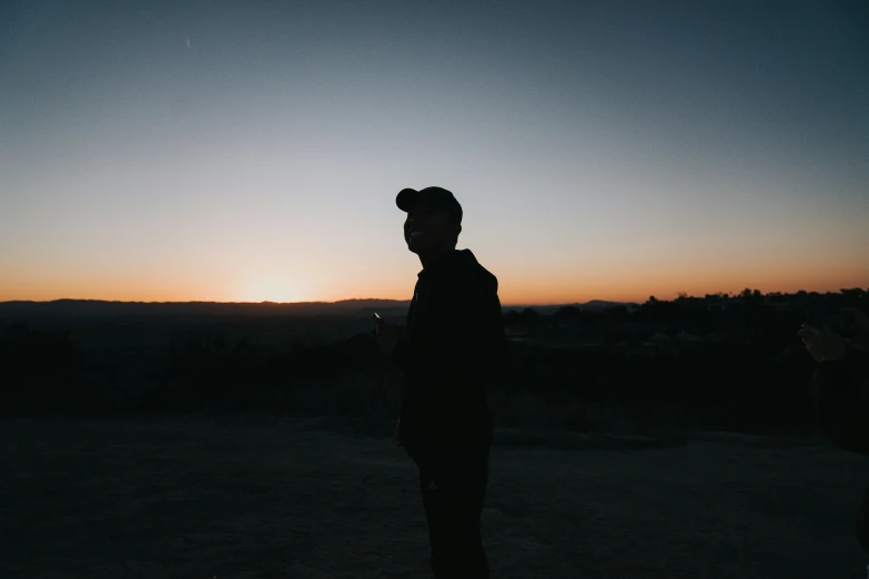 a man standing next to a tall mountain