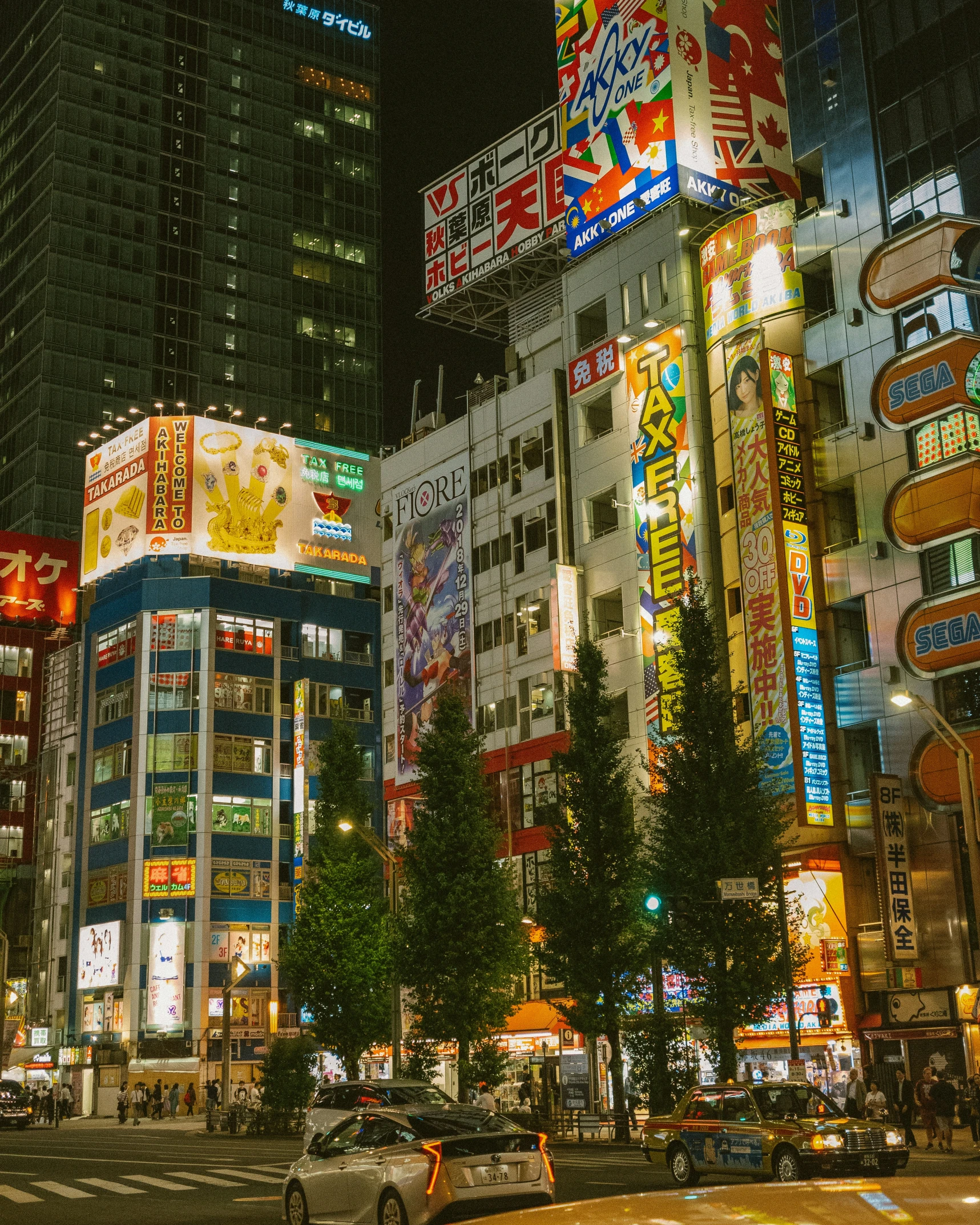 a busy street with neon signs on buildings