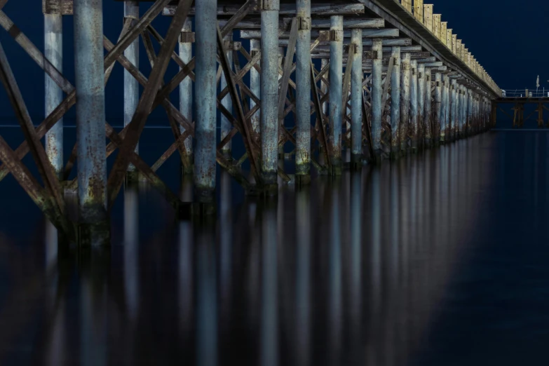 the blue and yellow lights on the pier look beautiful