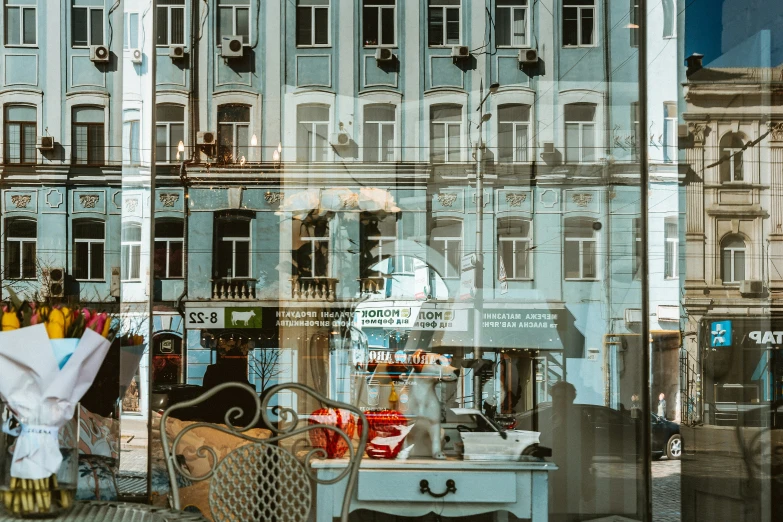 a storefront window shows clothes hanging and an assortment of shoes in the background